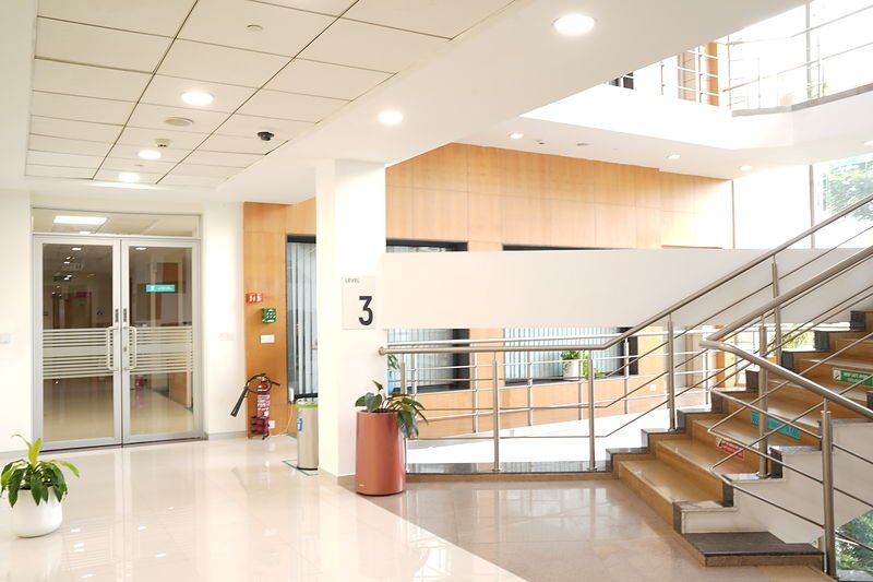 Third floor landing with a daylit central void and open feature stair.
